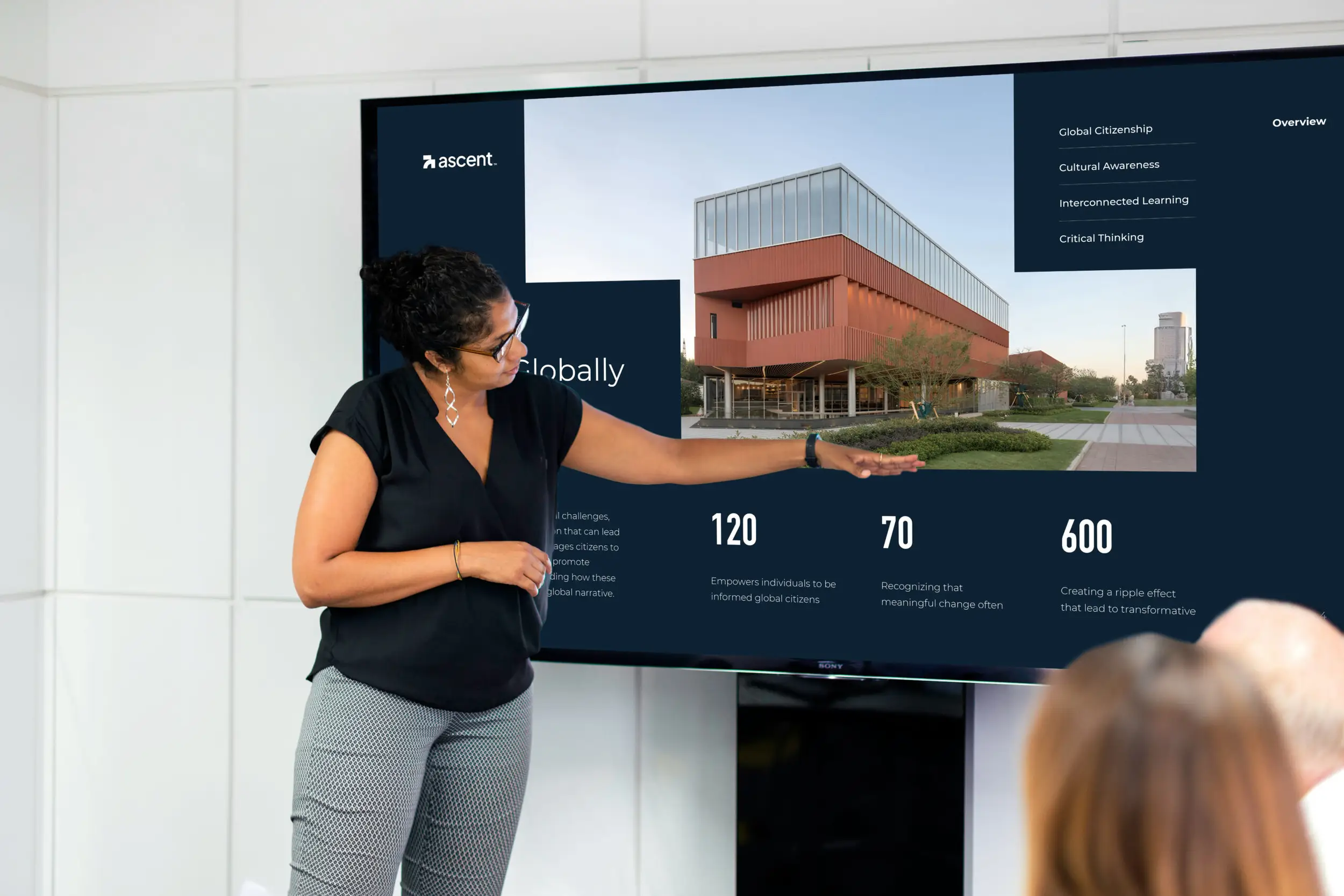 A woman presents a customized interactive PowerPoint designed to meet client needs and feedback, highlighting the flexibility and adaptability of interactive presentation design